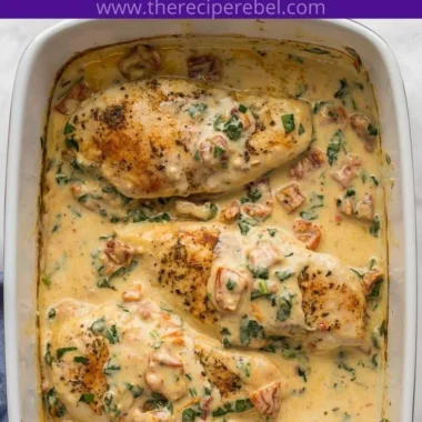 Baked Tuscan Chicken Breast garnished with fresh herbs and served on a plate