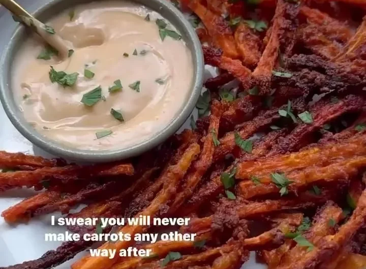 Crispy carrot fries served on a plate with a dipping sauce