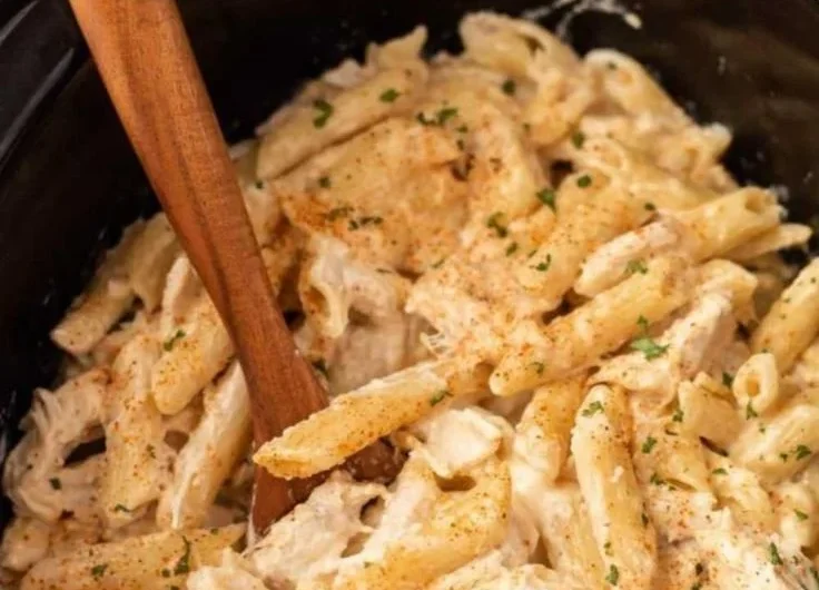 Crock Pot Cajun Chicken Pasta bowl garnished with herbs and spices
