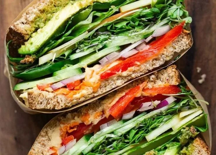 Delicious veggie sandwich with fresh vegetables and toppings on whole grain bread