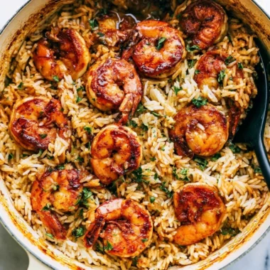 Delicious Cajun shrimp served over fluffy rice for a flavorful meal.