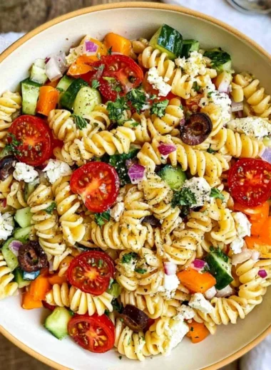 Colorful and fresh easy pasta salad with vegetables and dressing on a plate