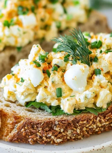 Creamy egg salad with dill in a bowl, garnished and ready to serve.
