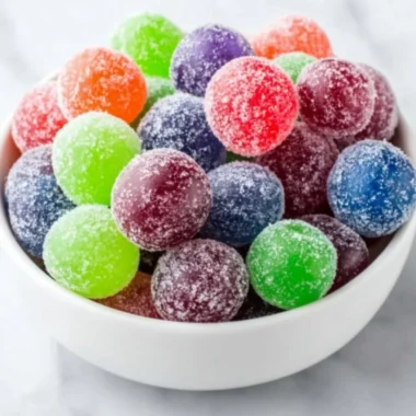 A bowl of bright green Kool-Aid Grapes, a colorful snack recipe for kids.