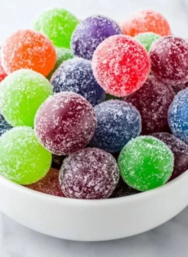 A bowl of bright green Kool-Aid Grapes, a colorful snack recipe for kids.