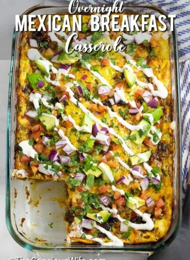 Delicious Mexican breakfast casserole topped with cheese and fresh ingredients.