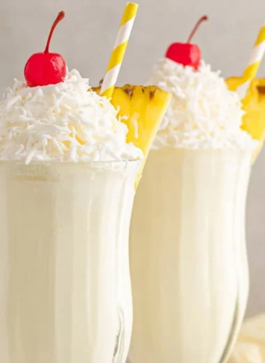 Delicious Pina Colada Milkshake topped with whipped cream and pineapple