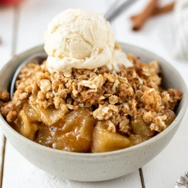 A delicious serving of easy apple crisp topped with ice cream