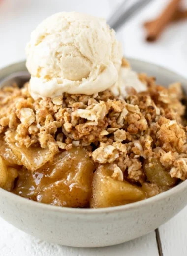 A delicious serving of easy apple crisp topped with ice cream