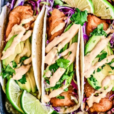 Plated cozy Baja Fish Tacos with fresh ingredients and toppings