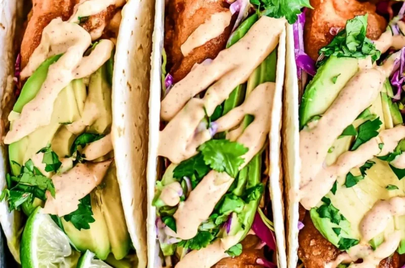 Plated cozy Baja Fish Tacos with fresh ingredients and toppings