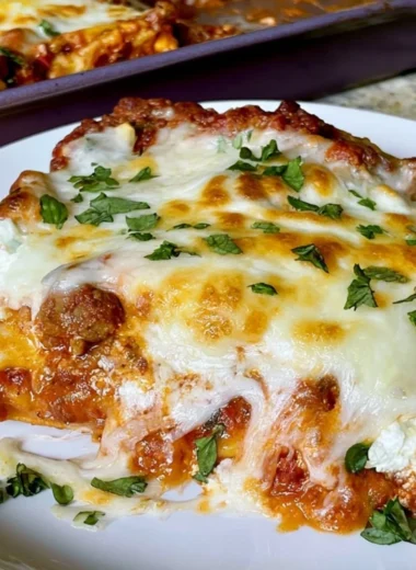 Cozy sheet pan lasagna served on a wooden table with fresh basil and cheese