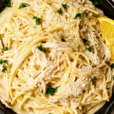 Creamy lemon chicken pasta served in a bowl with fresh herbs