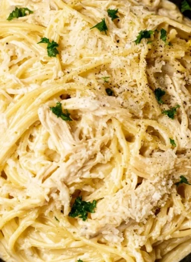 Creamy lemon chicken pasta served in a bowl with fresh herbs