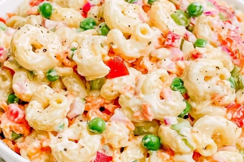 Creamy macaroni salad with vegetables and dressing in a serving bowl