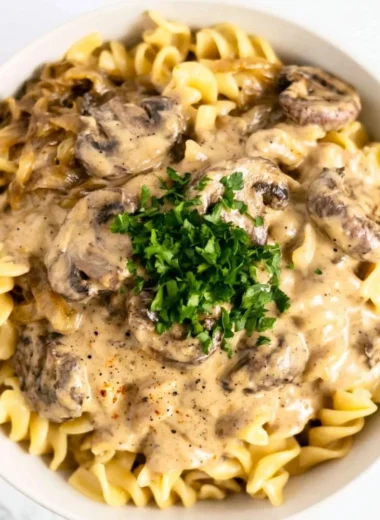 Creamy vegetarian mushroom stroganoff served in a bowl with a sprinkle of herbs.