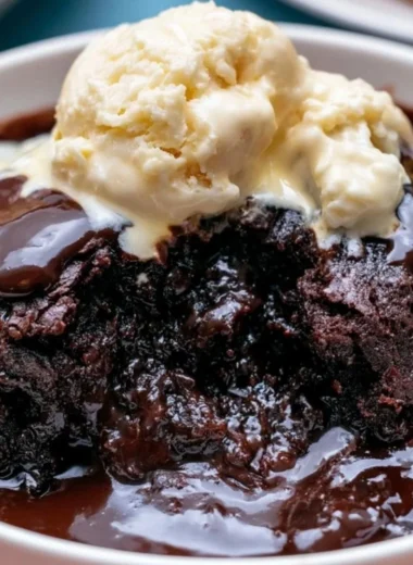 Delicious crockpot pudding brownies served on a plate with chocolate drizzle
