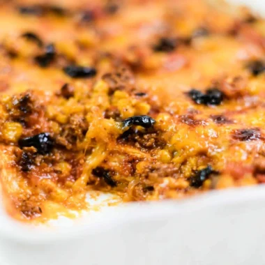 Delicious easy taco bake topped with cheese and fresh toppings