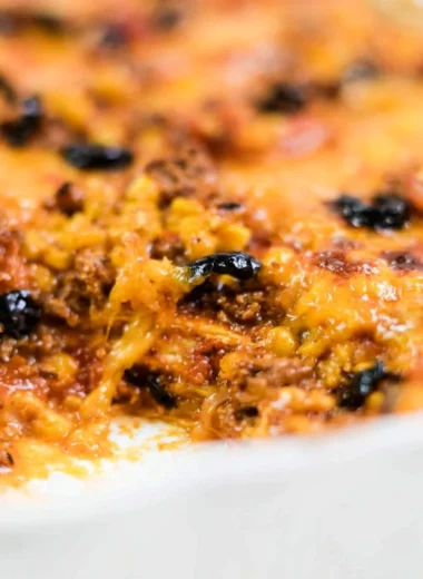 Delicious easy taco bake topped with cheese and fresh toppings