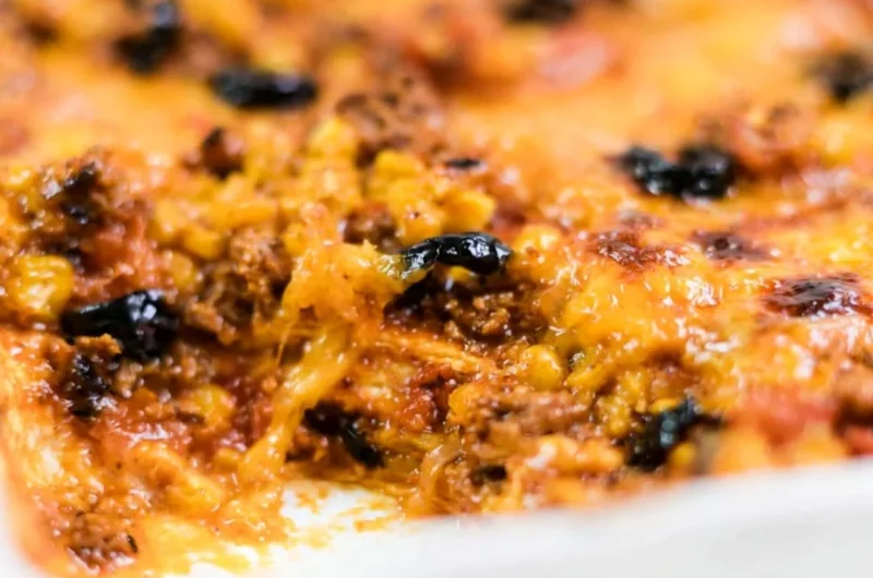 Delicious easy taco bake topped with cheese and fresh toppings