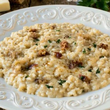 Delicious Three Cheese Risotto topped with herbs and melted cheese