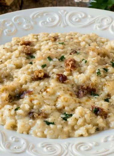 Delicious Three Cheese Risotto topped with herbs and melted cheese