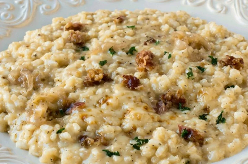 Delicious Three Cheese Risotto topped with herbs and melted cheese