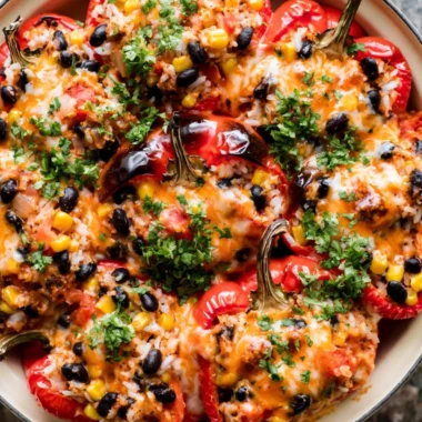 Colorful vegetarian stuffed peppers filled with rice, beans, and vegetables