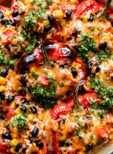 Colorful vegetarian stuffed peppers filled with rice, beans, and vegetables