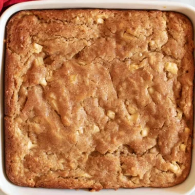 Freshly baked Amish Apple Cake topped with apples and spices.
