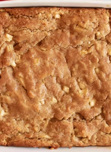 Freshly baked Amish Apple Cake topped with apples and spices.