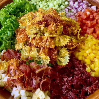 Bowl of Crispy Italian Pasta Salad with fresh vegetables and herbs