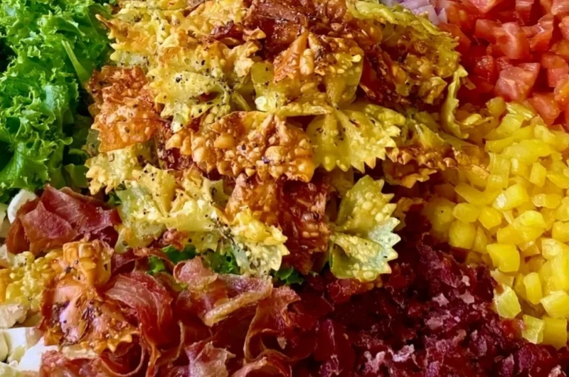 Bowl of Crispy Italian Pasta Salad with fresh vegetables and herbs