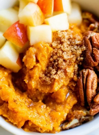 Sweet potato breakfast bowl topped with pecans and apples for a nutritious meal